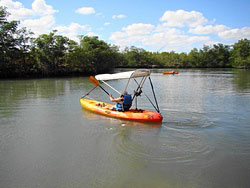 Bimini top for sit on top kayak with fishing rod holders attached to sun shade support poles. Click on image to enlarge.