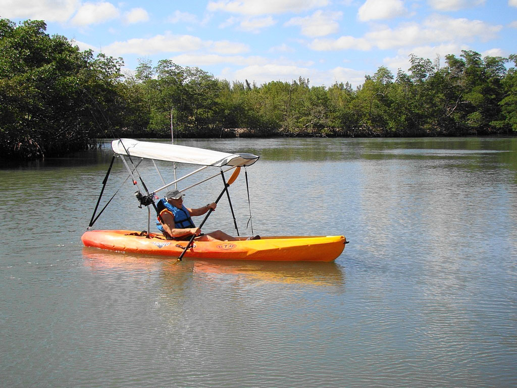 on top kayak with fishing rod holders attached to sun shade support 