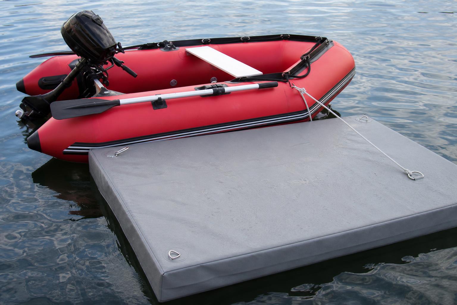 Close-up illustration of a foam-filled floating dock platform bobbing gently on calm water next to a small inflatable di