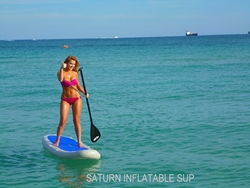 Girl enjoy riding inflatable paddle board SUP