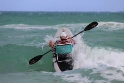 Surfing waves while sitting in a comfy beach chair.