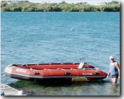 Below is not a very good photo, but it may serve to remind you of the 4 foot gash I had on the port chamber of my 14-foot Saturn. Since this was taken, I have put on the big motor and been bopping all around the huge bay of Culebra, PR. She runs like new!!! I can hardly believe it.