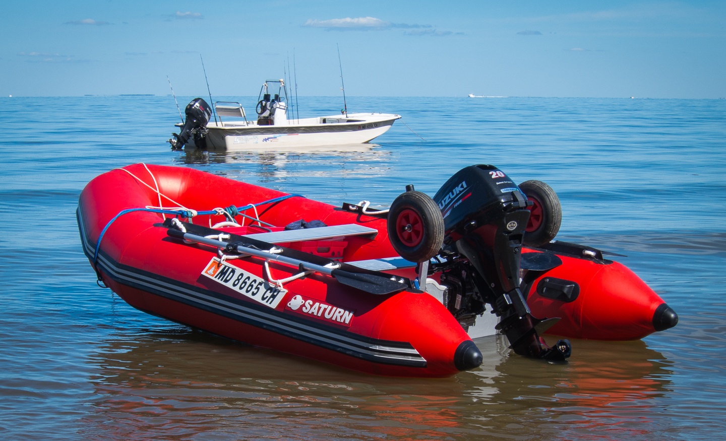 red inflatable boat in the middle of the water