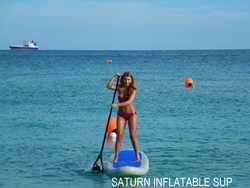 Girl turning inflatable paddle board around