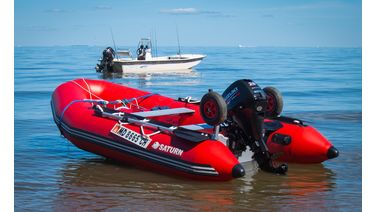 red inflatable boat in the middle of the water