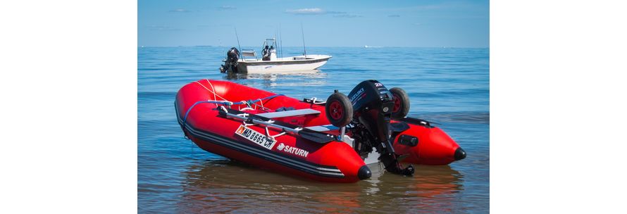 red inflatable boat in the middle of the water